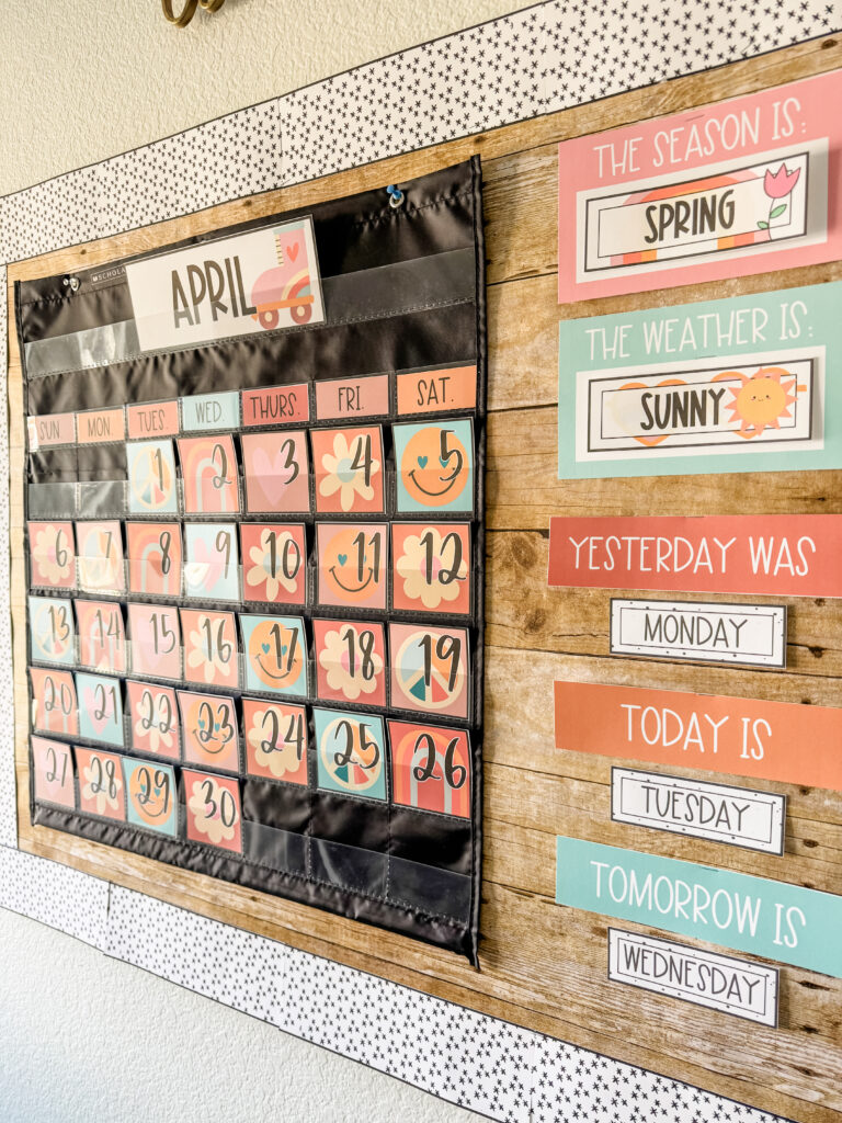 This image shows a groovy classroom calendar display with weather cards off to the side. 