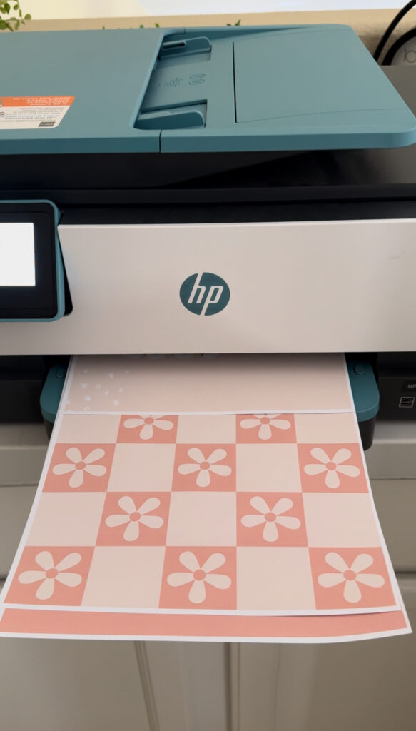 This image shows my hp printer, printing pastel classroom decor posters.