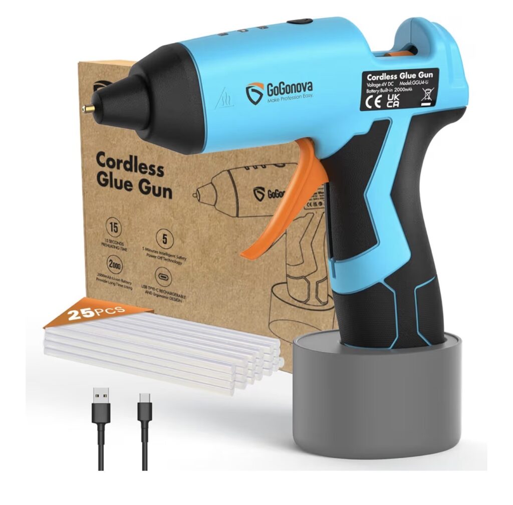 This image shows a blue cordless glue gun, some glue sticks, and a charging cord included for the gun. 