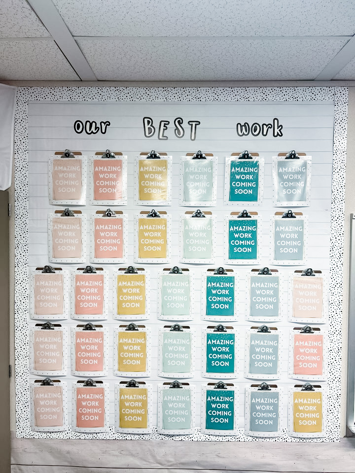 This image shows an Amazing Work Coming Soon display with clipboards hung up for each student on the wall of an elementary classroom.