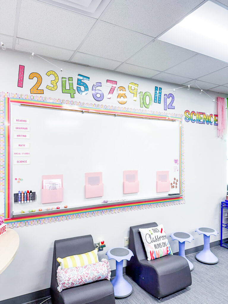 This image shows a wall in a 3rd grade classroom with bright skip counting numbers, cozy chairs, and a bulletin board dedicated to displaying learning targets.