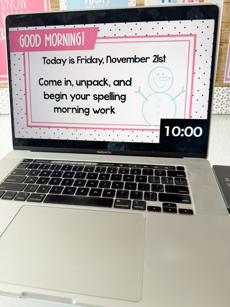This image shows a computer with a good morning slide template with a winter design.