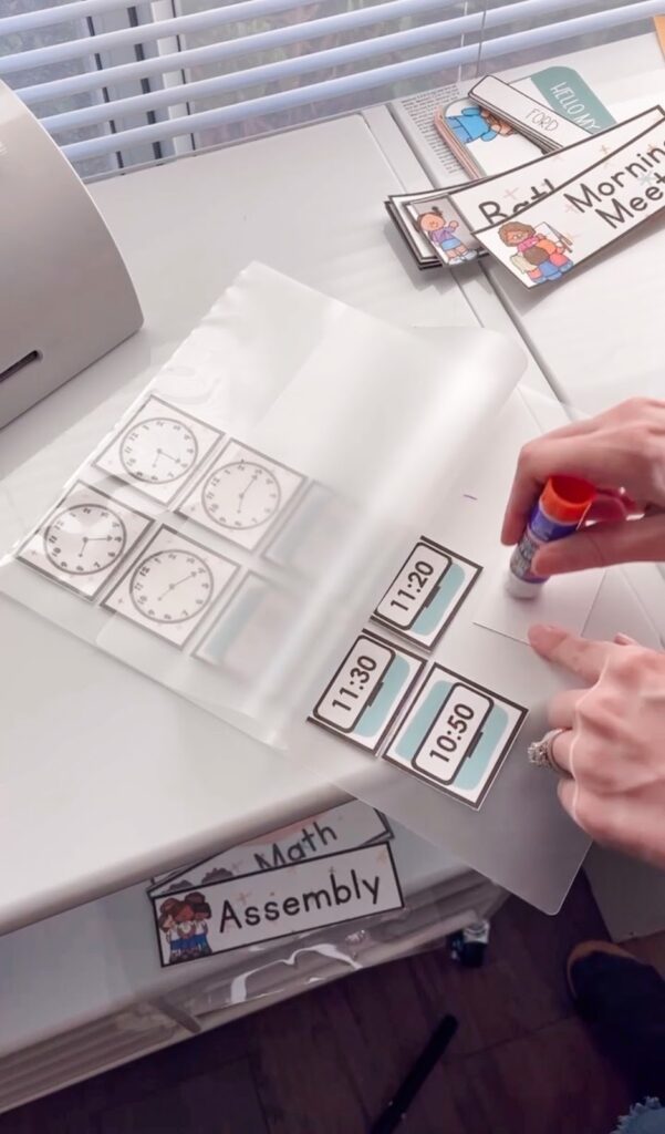 This image shows a teacher adding glue to the back of items she wants to laminate before sending them through the laminator. 