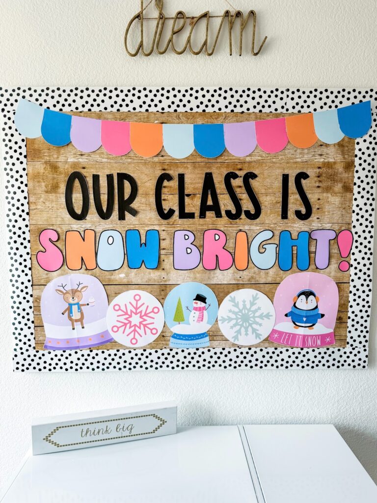 This image shows a winter-themed bulletin board that reads "Our Class is Snowbright" and has snowglobes with a reindeer, penguin, and snowman running along the bottom as decoration.