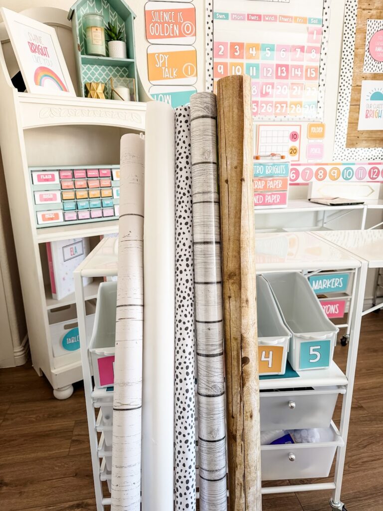 This image shows five different rolls of bulletin board paper in a classroom. 