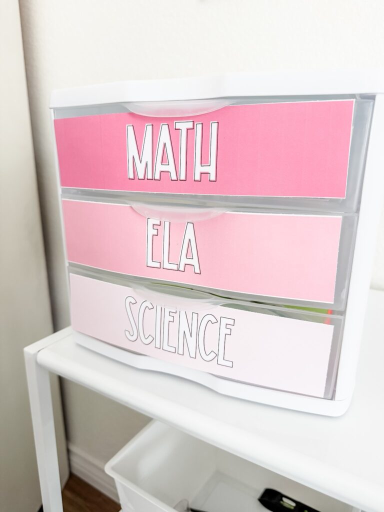 This image shows a Sterilite three drawer bin with solid pink labels on the drawers indicating what is inside. 