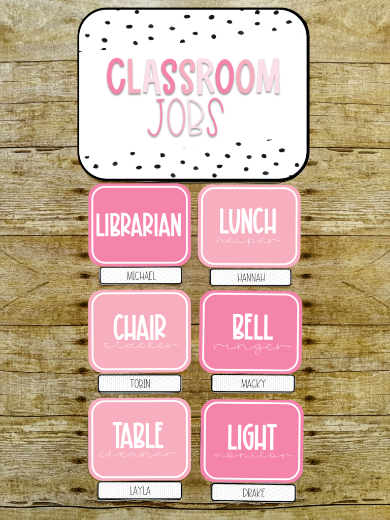 This image shows a mockup of an upper elementary classroom jobs display. Each job card has the name of the job on a solid pink background. Underneath the job card is a card with a student's name. 