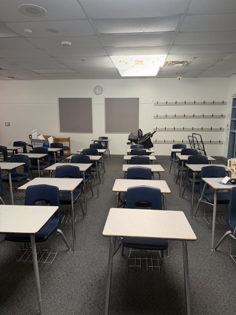 This image shows a classroom with desks set up in rows.