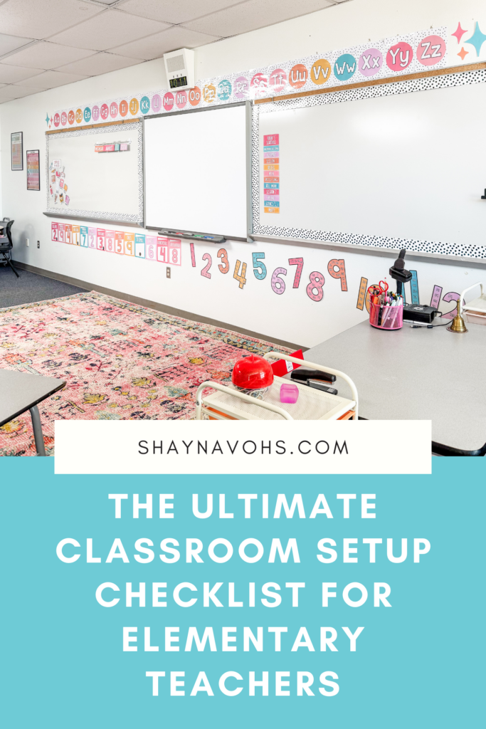 This image shows the front of a classroom with a whiteboard, lots of learning supports on the walls, and a bright, colorful rug on the floor. The text on the image reads "The ultimate classroom setup checklist for elementary teachers."